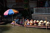 Thailand, Locals sell fruits, food and products at Damnoen Saduak floating market near Bangkok 